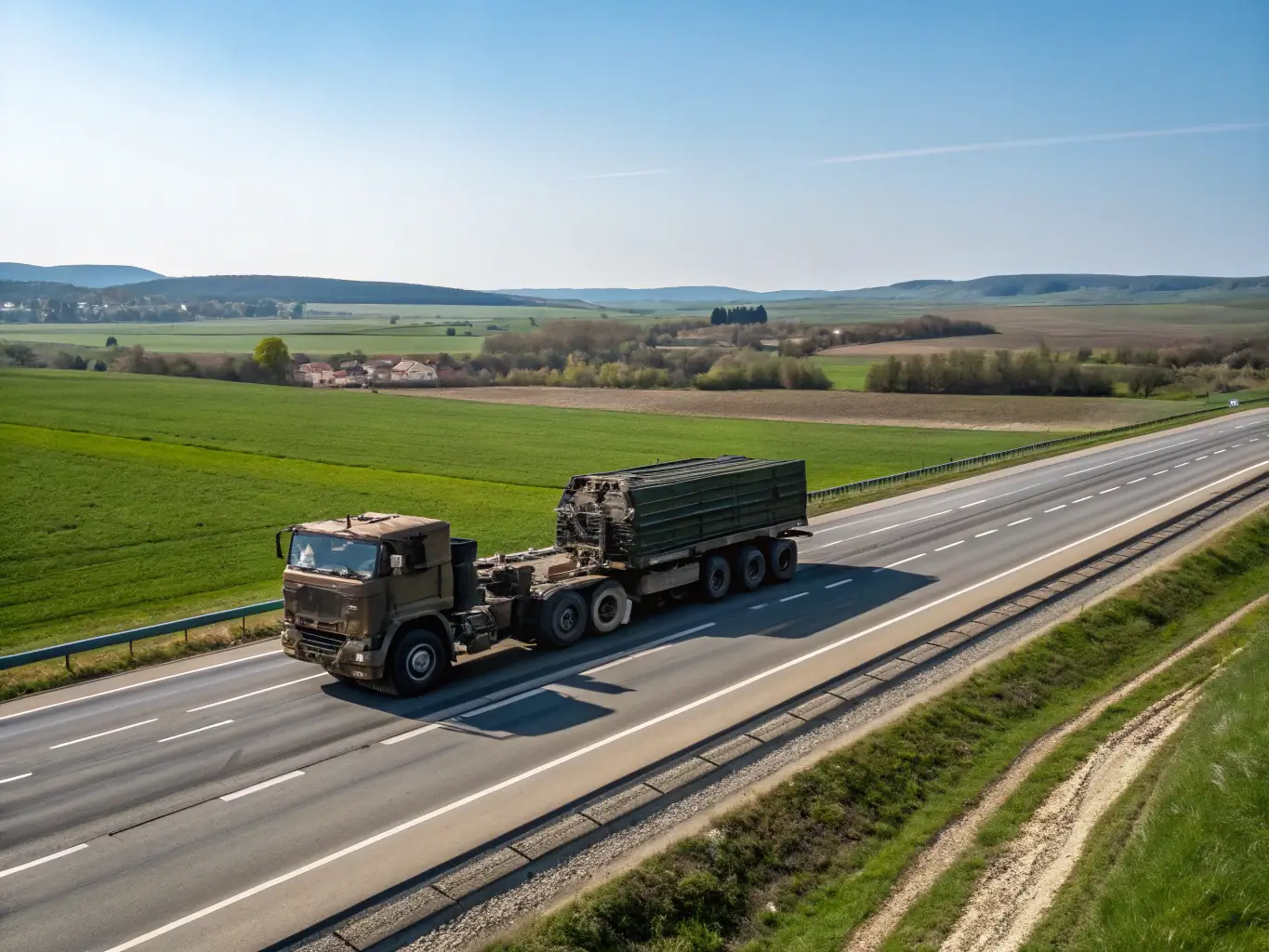 A specialized flatbed truck carrying oversized machinery, secured with heavy-duty straps, showcasing A2Z Freight Transportation's expertise in handling specialized cargo.